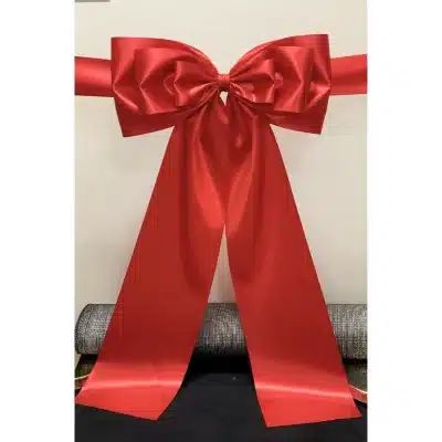 ribbon cutting ceremony with big tri-loop bow in red